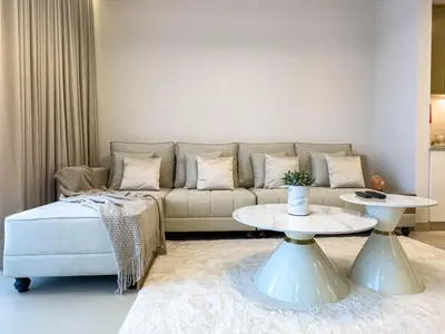 a living room with a couch and a table at Luxury Redefined 1BR Apartment in Emaar 5242 in Dubai