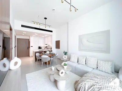 a white living room with a couch and a table at Dubai JVC 1BR l Stylish Stay with Top Amenities in Dubai