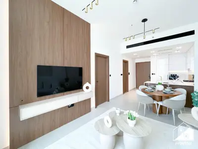 a living room with a television and a dining room at Dubai JVC 1BR l Stylish Stay with Top Amenities in Dubai