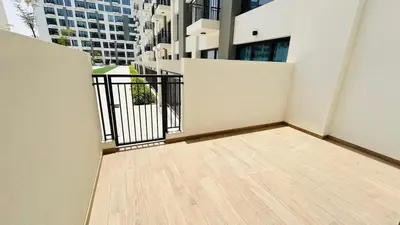 an empty balcony of a building with buildings in the background at studio in best community-podium level with terrace in Dubai