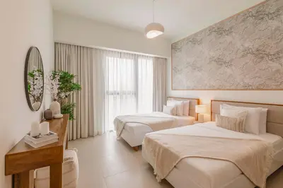 a hotel room with two beds and a mirror at Sarora One - Japandi-Inspired 2-Bedroom Apartment in Act One, Downtown Dubai with Balcony & Burj Khalifa View in Dubai