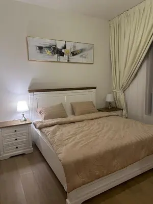 a bedroom with a large bed and a nightstand and a bed sidx sidx sidx at 2BR Apartment with full sea view & Burj Khalifa in Dubai