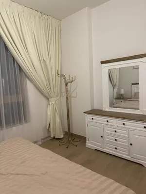 a bedroom with a bed and a mirror and a dresser at 2BR Apartment with full sea view & Burj Khalifa in Dubai