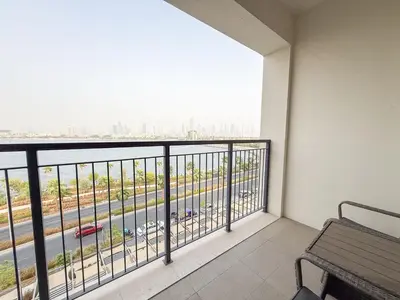 a balcony with a bench and a view of a highway at 2BR Apartment with full sea view & Burj Khalifa in Dubai