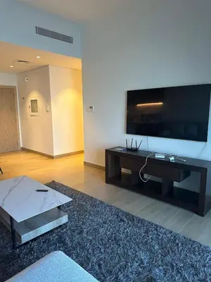 a living room with a large flat screen tv at 2BR Apartment with full sea view & Burj Khalifa in Dubai