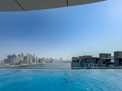 a swimming pool with a view of the city at Seven Palm Jumeirah Studio - Private Beach Access in Dubai