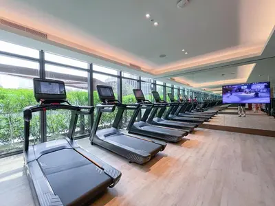 a row of treadmills in a gym with a television at Shukr شكر - Luxury 3BR with Panoramic Burj Khalifa & Fountain Views - Address Residence Dubai Opera - 2 Min Walk to Dubai Mall in Dubai