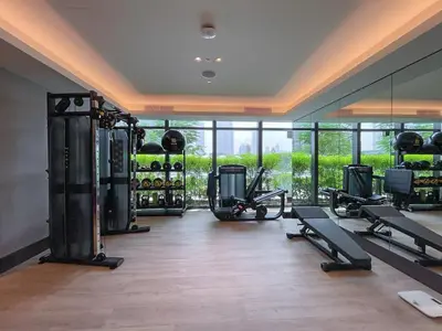 a gym with cardio equipment and a large mirror at Shukr شكر - Luxury 3BR with Panoramic Burj Khalifa & Fountain Views - Address Residence Dubai Opera - 2 Min Walk to Dubai Mall in Dubai