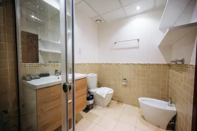 a bathroom with a toilet and a sink at Top Holiday Location - Walk to Beach - Free Pool & Gym in Dubai