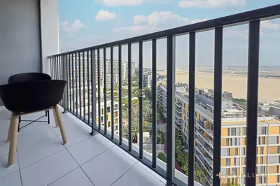 a balcony with a chair and a view of a city at Cozy Studio With Style Midtown Retreat - Impz in Dubai