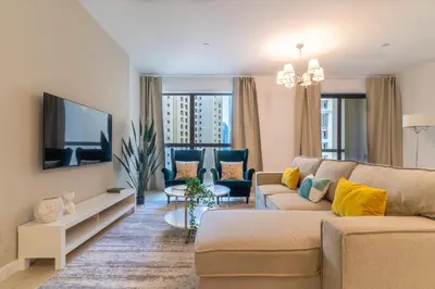 a living room with a couch and a tv at The Smart Concierge - Murjan in Dubai