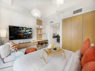 a living room with a couch and a table at Livin' Holiday - Studio - Cozy Flat in Business Bay in Dubai