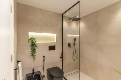 a shower stall in a bathroom with a toilet at The Smart Concierge - Elite Residence in Dubai