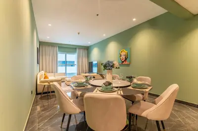 a dining room with a table and chairs at The Smart Concierge - Elite Residence in Dubai