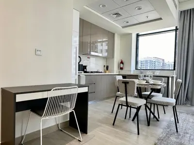 a kitchen and dining room with a table and chairs at Upscale 1 Bedroom Apartment - Azizi Riviera 27 - Allsopp & Allsopp in Dubai