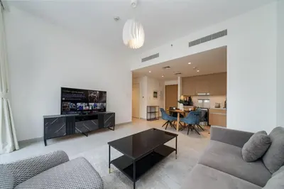 a living room with a couch and a table at Elegant 1 Bed Creek Beach Stay with Beach Access in Dubai