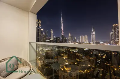 a room with a view of a city at night at Luxury Stay Skyline Burj View in Dubai