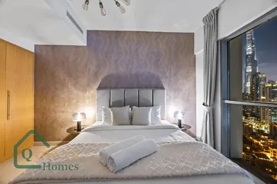 a bedroom with a large bed and a window at Luxury Stay Skyline Burj View in Dubai