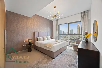 a bedroom with a bed and a large window at Luxury Stay Skyline Burj View in Dubai