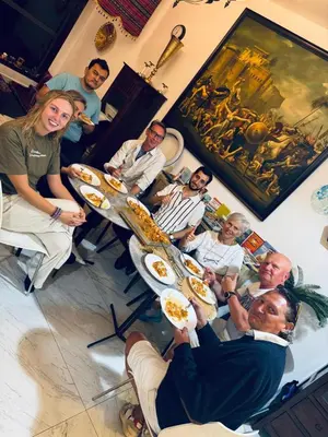 a group of people sitting at tables with plates of food at dreams stay in Dubai