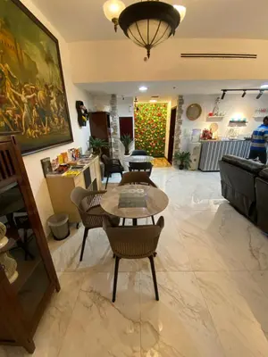 a living room with a table and chairs at dreams stay in Dubai