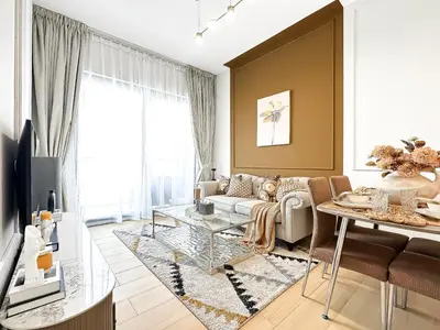 a living room with a couch and a table at Modern 1BR Haven in Prime JVC Spot in Dubai