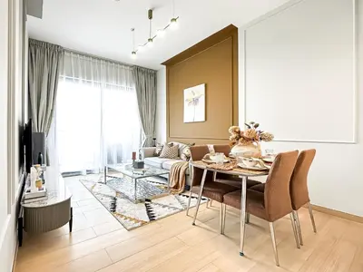a living room with a table and a couch at Modern 1BR Haven in Prime JVC Spot in Dubai