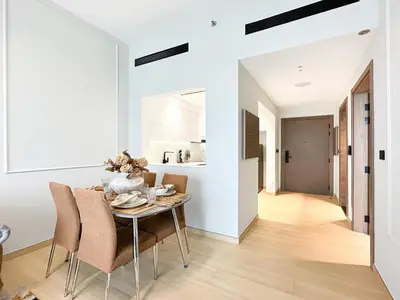 a dining room with a table and chairs at Modern 1BR Haven in Prime JVC Spot in Dubai