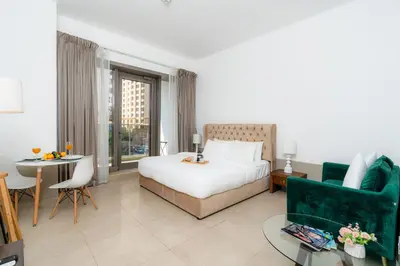 a hotel room with a bed and a table at Cozy - Accessible to Tram - Convenient in Dubai