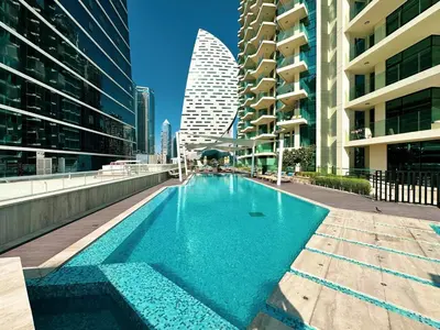 a swimming pool in a city with tall buildings at FIRST CLASS 2BR Luxury Canal & Pool Views in Dubai