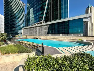 a swimming pool in a city with tall buildings at FIRST CLASS 2BR Luxury Canal & Pool Views in Dubai