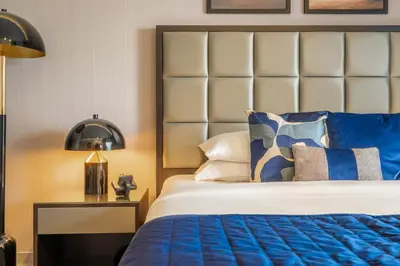 a bedroom with a bed with a blue comforter at GuestReady - City Nest | Balcony | Majestine Tower in Dubai