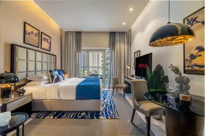 a bedroom with a bed and a table and chairs at GuestReady - City Nest | Balcony | Majestine Tower in Dubai