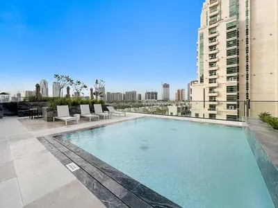 a swimming pool on the roof of a building at Cozy 1BR Apartment with Pool & Parking JVC Dubai in Dubai