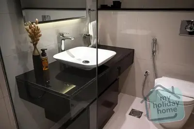 a bathroom with a sink and a toilet at Burj Khalifa View - Cozy 1BR - Pool - Gym - Spa in Dubai