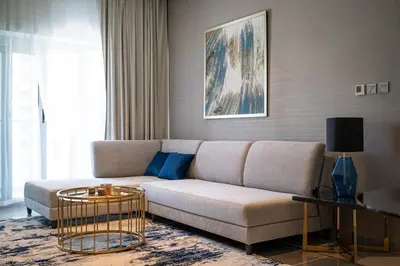 a living room with a couch and a table at Burj Khalifa View - Cozy 1BR - Pool - Gym - Spa in Dubai