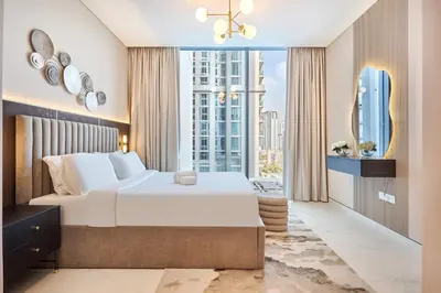 a bedroom with a large bed and a large window at STAY BY LATINEM Luxury 2BR Holiday Home CVG 807 Near Downtown in Dubai
