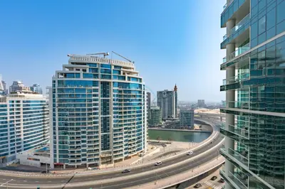 a city with tall buildings and a highway at Walking Distance to Bluewaters Island, with The Walk JBR right at your Door and Private Beach Access, Al Bateen Residences, JBR by Deluxe Holiday Homes in Dubai