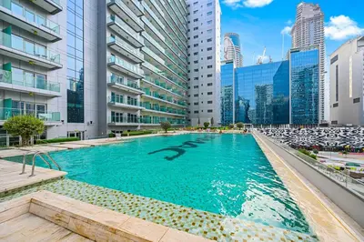 a swimming pool in a city with tall buildings at Heart of Downtown - Dubai Mall & Burj next door in Dubai
