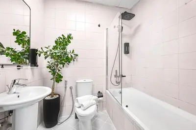 a bathroom with a toilet and a sink and a shower at Chic Marina View - Timeless Studio Escape in Dubai