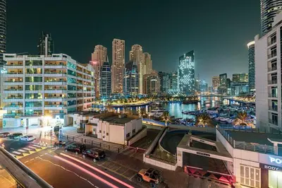 a city skyline at night with buildings and cars at Chic Marina View - Timeless Studio Escape in Dubai