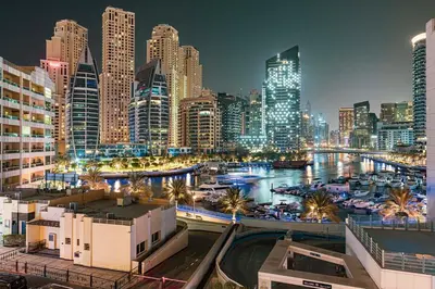 a city skyline at night with a marina at Chic Marina View - Timeless Studio Escape in Dubai