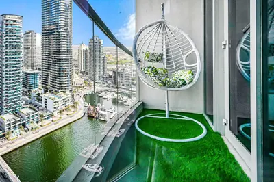 a balcony with a view of a city at Elegant 3-Bedroom Haven - Panoramic Marina Views in Dubai