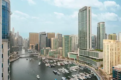 a view of a city with boats in the water at Elegant 3-Bedroom Haven - Panoramic Marina Views in Dubai