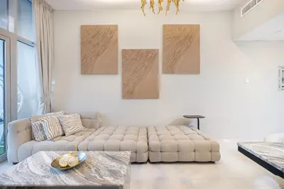 a living room with a couch and a table at Elegant 3-Bedroom Haven - Panoramic Marina Views in Dubai
