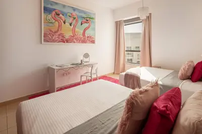 a living room with two beds and a table at Frank Porter - Rimal 1, JBR in Dubai