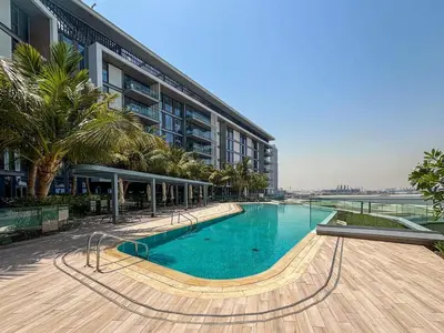a swimming pool in front of a building at Frank Porter - Bluewaters Residences 5 in Dubai