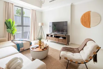a living room with a couch and a tv at Frank Porter - Dunya Tower, Downtown in Dubai
