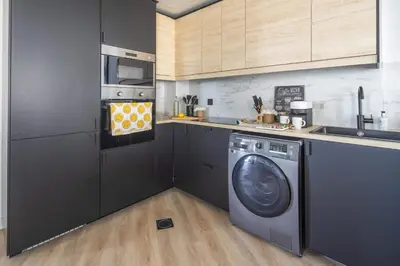 a kitchen with a washing machine and a microwave at Frank Porter - Lago Vista Tower A in Dubai