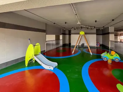 a childrens play area with two swings and a slide at Frank Porter - Dt1 Tower, Downtown Dubai in Dubai